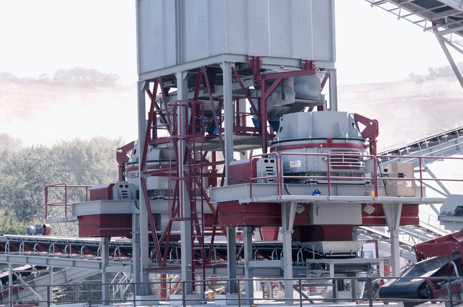GELEN vertical shaft impact crusher on a steel structure below the feed silo