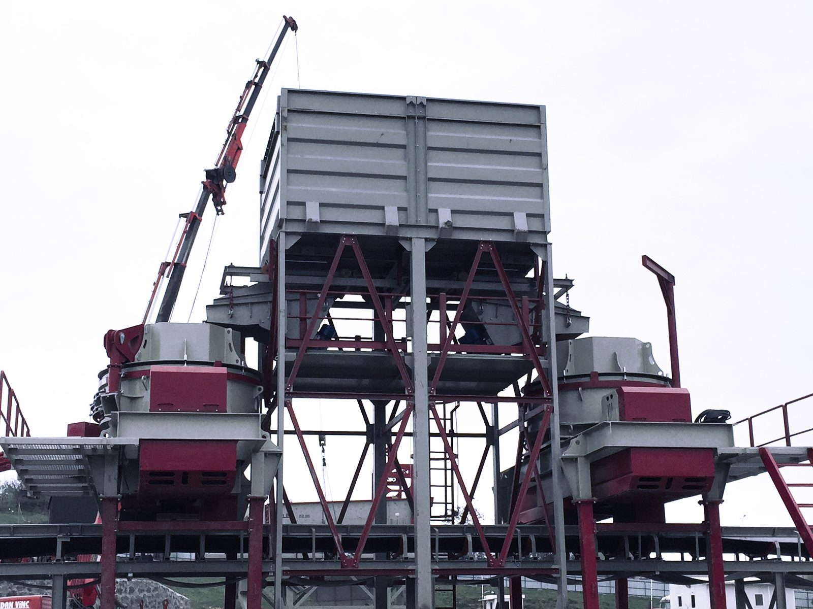 Two GELEN vertical shaft impact crushers under feed bins during plant installation